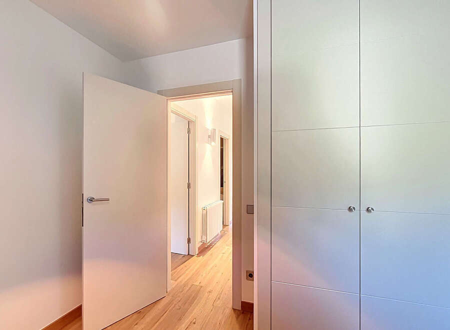 Step into this beautifully designed property featuring a bright and airy hallway with hardwood floors.