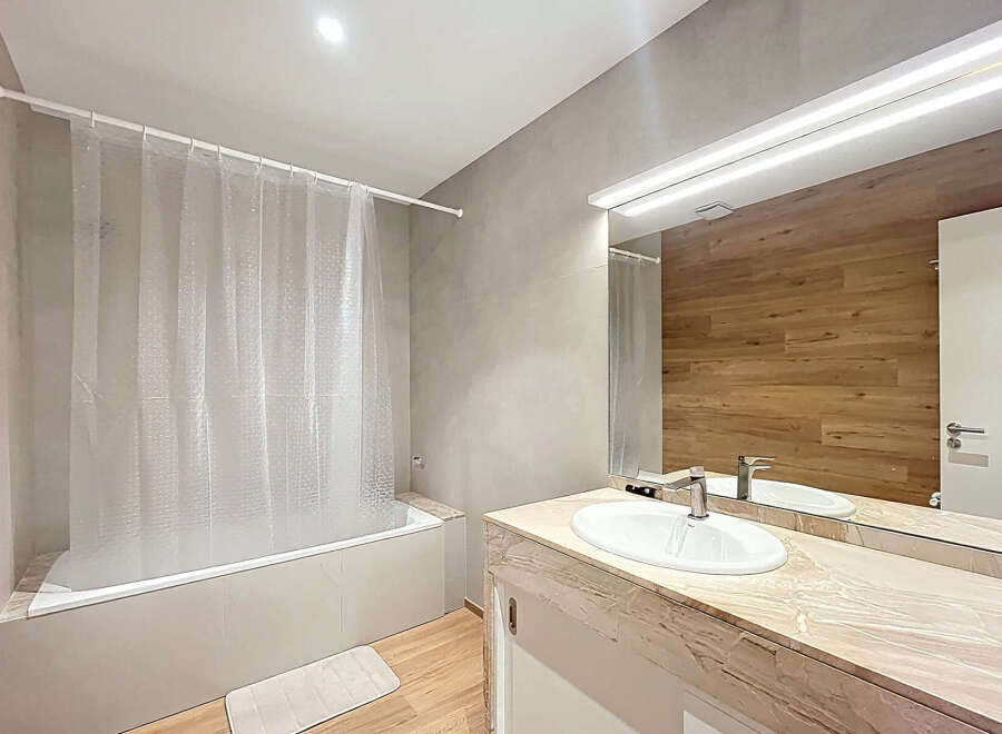 Step into a modern bathroom oasis! This space boasts a sleek design with a combination of neutral tones and natural wood accents.