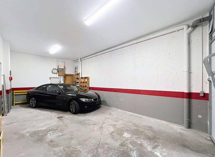 Spacious garage with a modern design, perfect for storing vehicles or creating a workshop.