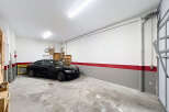 Spacious garage with a modern design, perfect for storing vehicles or creating a workshop.
