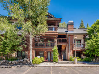 Discover a stunning property featuring a beautiful exterior with wooden accents and balconies, perfect for enjoying the outdoors.
