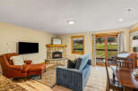 This cozy living space features a stone fireplace, perfect for those chilly evenings.