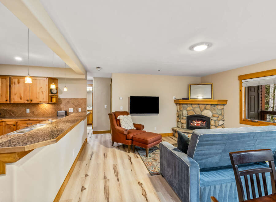 This cozy living space features a stone fireplace, perfect for relaxing evenings.