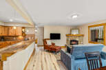 This cozy living space features a stone fireplace, perfect for relaxing evenings.