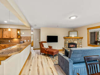 This cozy living space features a stone fireplace, perfect for relaxing evenings.