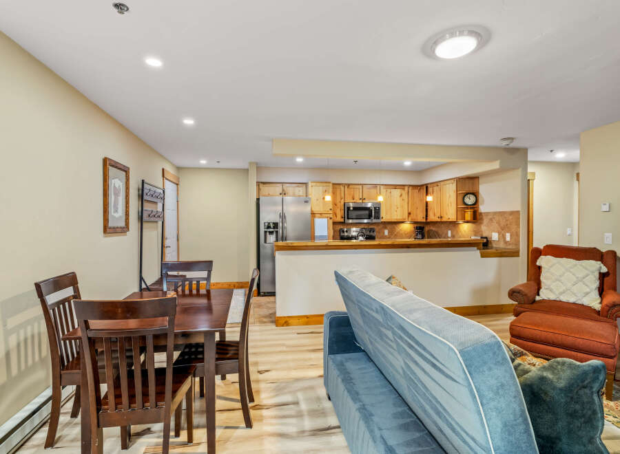 This cozy living space features a dining area, a comfortable sofa, and a well-equipped kitchen.