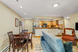 This cozy living space features a dining area, a comfortable sofa, and a well-equipped kitchen.