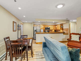 This cozy living space features a dining area, a comfortable sofa, and a well-equipped kitchen.