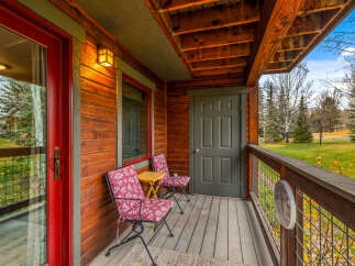 Enjoy the tranquility of this charming cabin's porch, perfect for morning coffee or evening relaxation.