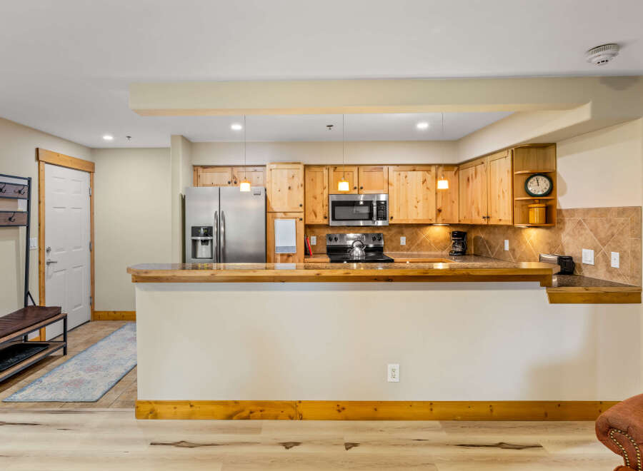 This stunning kitchen boasts beautiful wooden cabinetry, stainless steel appliances, and a sleek countertop.