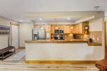 This stunning kitchen boasts beautiful wooden cabinetry, stainless steel appliances, and a sleek countertop.