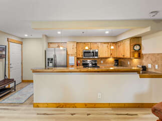 This stunning kitchen boasts beautiful wooden cabinetry, stainless steel appliances, and a sleek countertop.