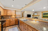 This stunning kitchen boasts beautiful wooden cabinetry and granite countertops, creating a warm and inviting atmosphere.