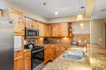 This stunning kitchen boasts beautiful wooden cabinetry and a modern stainless steel appliance package.