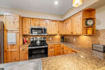 This stunning kitchen boasts beautiful wooden cabinetry, offering ample storage and a warm, inviting atmosphere.