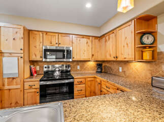 This stunning kitchen boasts beautiful wooden cabinetry, offering ample storage and a warm, inviting atmosphere.