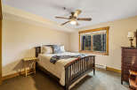 This cozy bedroom features a comfortable bed with soft bedding and a stylish throw blanket.