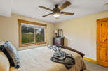 This cozy bedroom features a comfortable bed with a textured blanket and decorative pillows, perfect for a relaxing retreat.