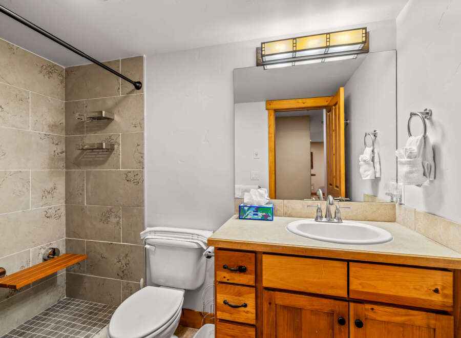 This inviting bathroom features a modern design with a touch of warmth.