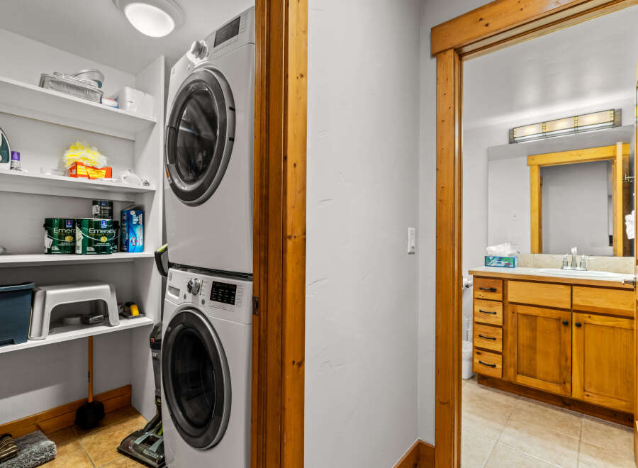 This charming property features a dedicated laundry area with a modern stacked washer and dryer, offering convenience and efficiency.