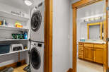 This charming property features a dedicated laundry area with a modern stacked washer and dryer, offering convenience and efficiency.