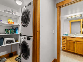 This charming property features a dedicated laundry area with a modern stacked washer and dryer, offering convenience and efficiency.
