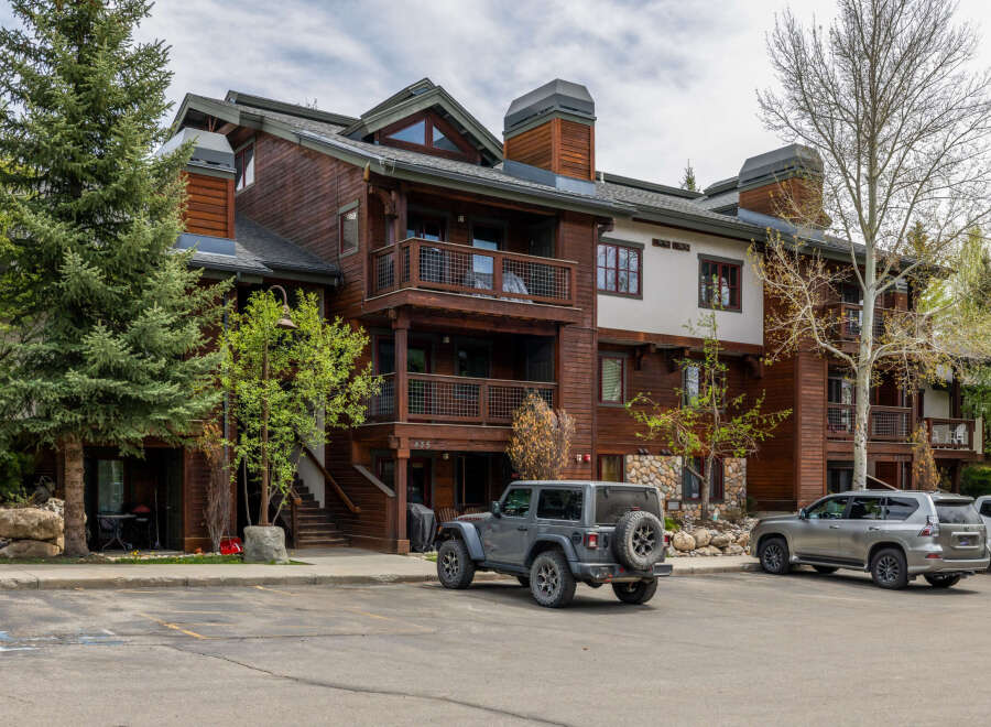 This stunning property boasts a beautiful exterior with a combination of wood and stone accents, creating a warm and inviting atmosphere.