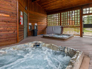 Relax and unwind in this luxurious hot tub oasis! This property features two hot tubs, perfect for enjoying a soothing soak.