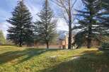 This stunning property boasts a serene setting with lush greenery and mature trees, creating a peaceful atmosphere.