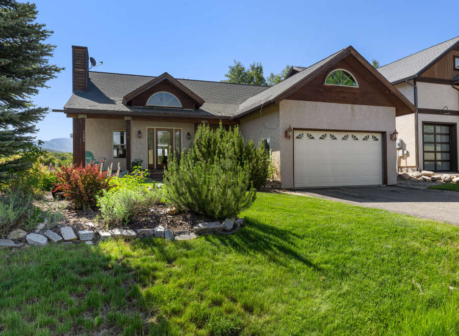 This stunning property features a beautifully landscaped yard and a charming exterior.