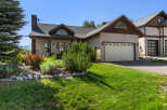 This stunning property features a beautifully landscaped yard and a charming exterior.