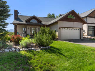 This stunning property features a beautifully landscaped yard and a charming exterior.