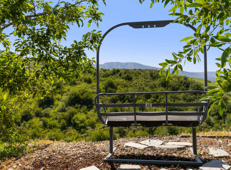 Enjoy breathtaking mountain views from this unique property! This image showcases a ski lift chair, offering a distinctive feature for potential buyers.