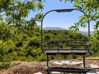 Enjoy breathtaking mountain views from this unique property! This image showcases a ski lift chair, offering a distinctive feature for potential buyers.