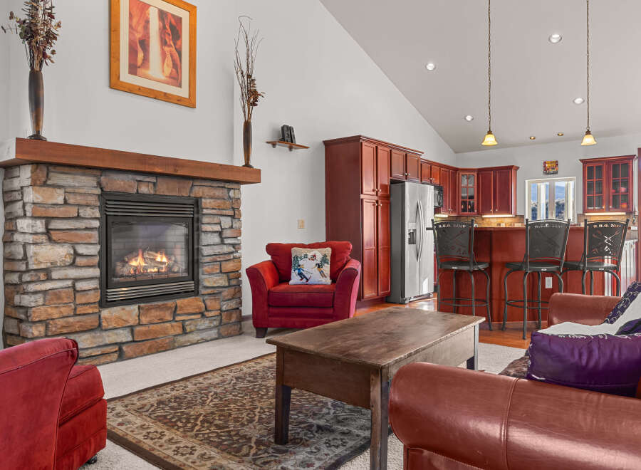 This stunning property boasts a cozy living room with a stone fireplace, perfect for relaxing evenings.