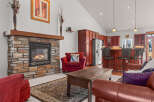 This stunning property boasts a cozy living room with a stone fireplace, perfect for relaxing evenings.