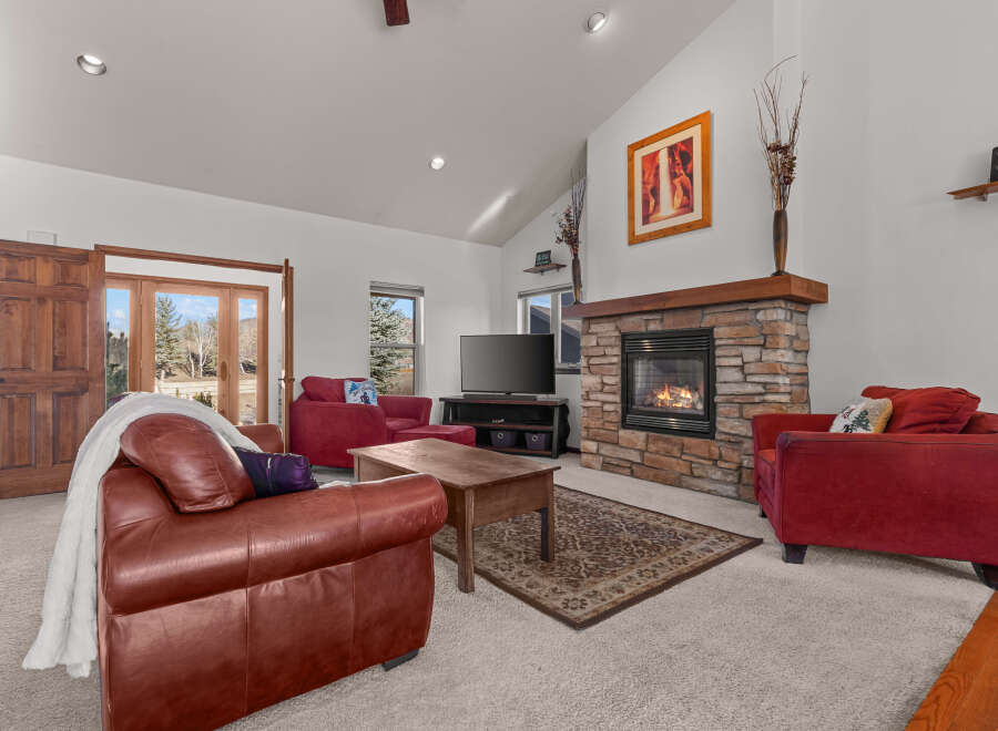 Step into a cozy living room with a stunning stone fireplace, perfect for those chilly evenings.