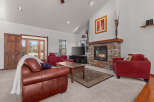 Step into a cozy living room with a stunning stone fireplace, perfect for those chilly evenings.