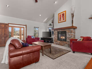 Step into a cozy living room with a stunning stone fireplace, perfect for those chilly evenings.