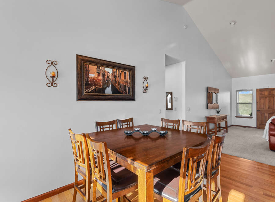 This dining area features a beautiful wooden table with seating for six, perfect for family meals or entertaining guests.