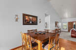 This dining area features a beautiful wooden table with seating for six, perfect for family meals or entertaining guests.