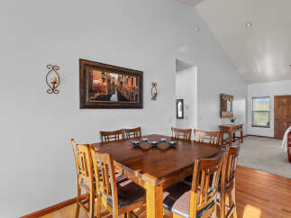 This dining area features a beautiful wooden table with seating for six, perfect for family meals or entertaining guests.