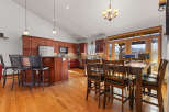 This stunning kitchen boasts rich, dark wood cabinetry and a spacious layout, perfect for both cooking and entertaining.