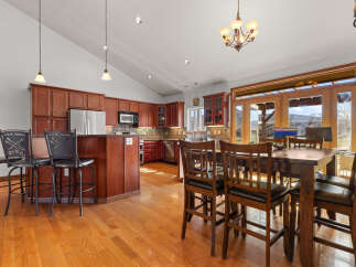This stunning kitchen boasts rich, dark wood cabinetry and a spacious layout, perfect for both cooking and entertaining.