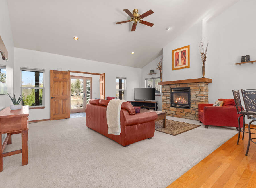 Step into luxury with this stunning living room, featuring a cozy fireplace and a spacious layout.