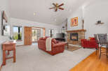 Step into luxury with this stunning living room, featuring a cozy fireplace and a spacious layout.