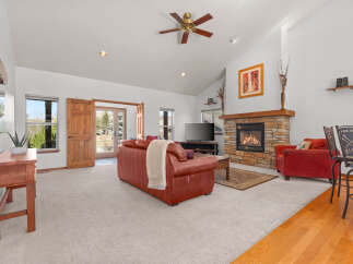 Step into luxury with this stunning living room, featuring a cozy fireplace and a spacious layout.