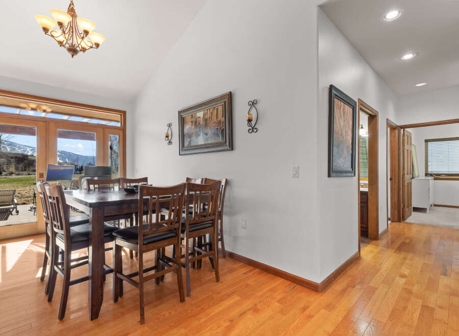 This stunning dining room boasts a warm and inviting atmosphere, perfect for hosting gatherings.