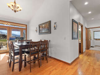 This stunning dining room boasts a warm and inviting atmosphere, perfect for hosting gatherings.