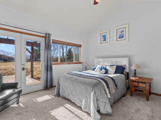 This inviting bedroom features a cozy bed with a stylish gray comforter and decorative pillows.